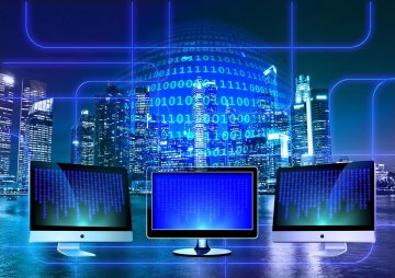 An artistic rendering of a modern computer network utilizing 3 screens against a night time background with electronic imagery superimposed.